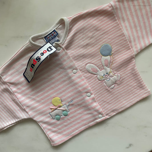 A pink and white striped infant cardigan with buttons down the center and a bunny and duck applique. 